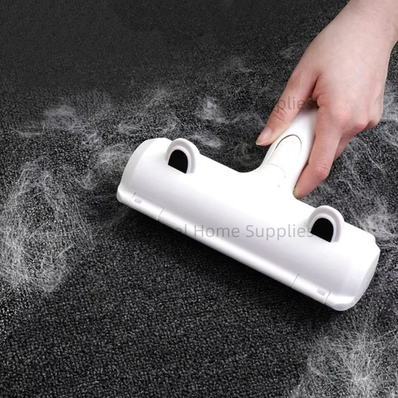 White pet hair roller collecting loose hair from dark fabric